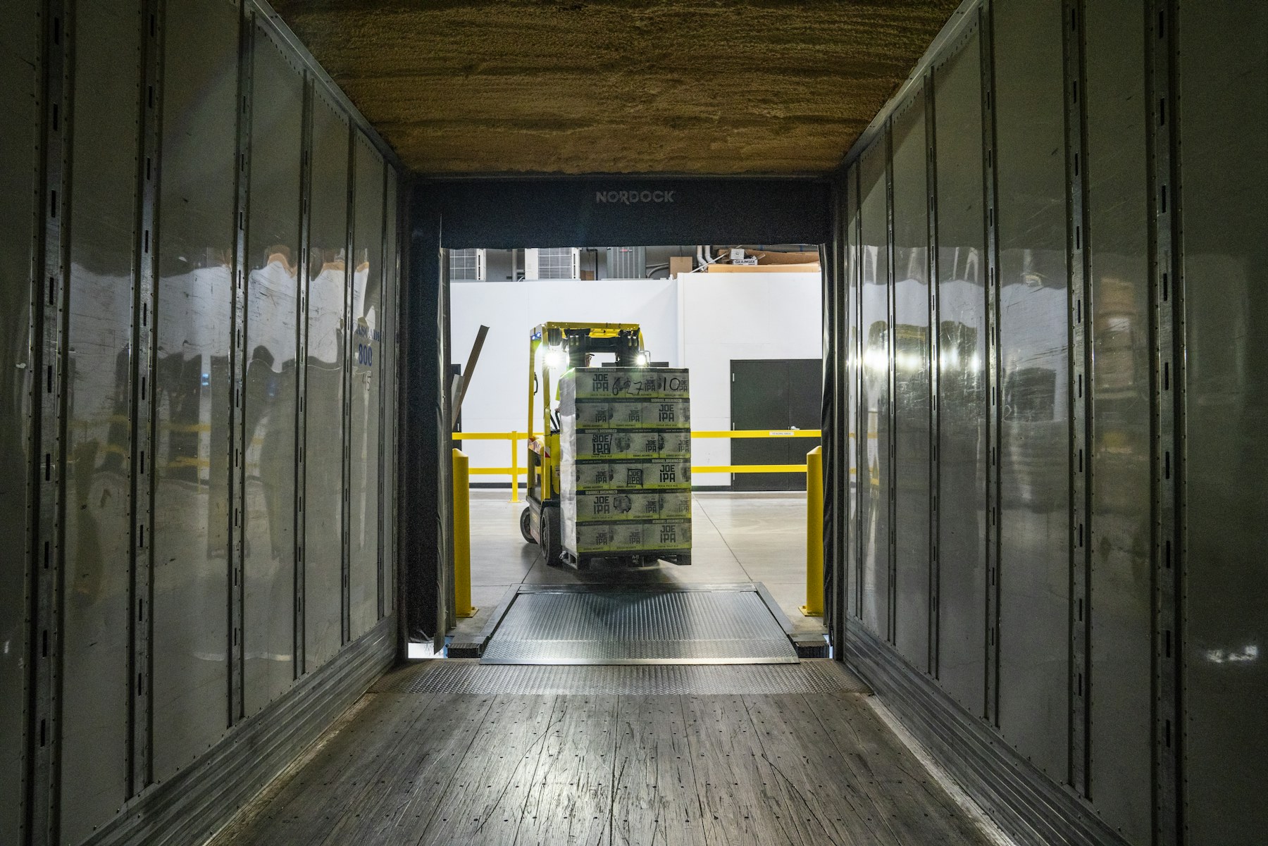 Forklift moving a pallet through a warehouse loading dock